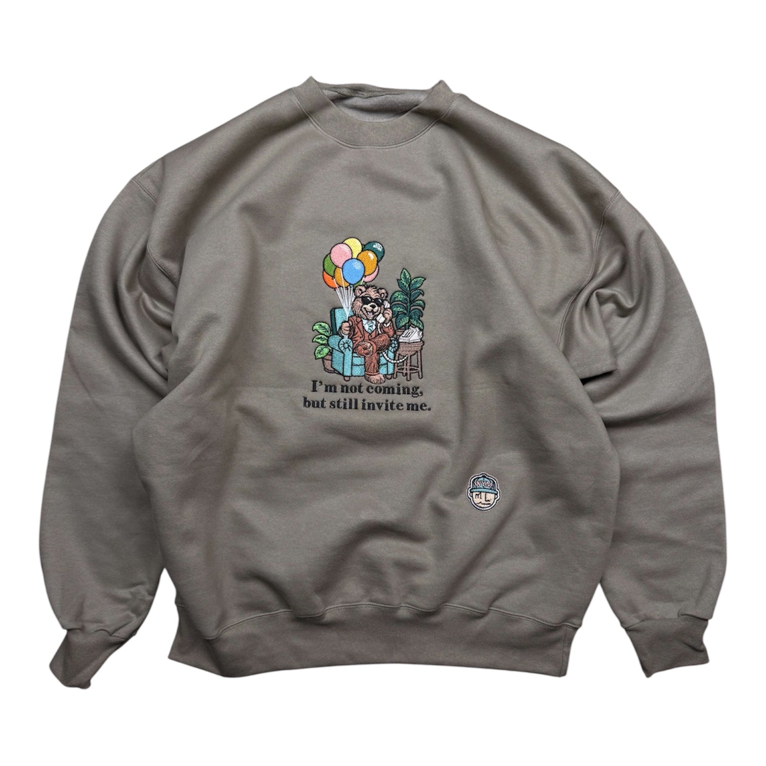 Olive colored sweatshirt with a graphic of a bear and balloons on a white background