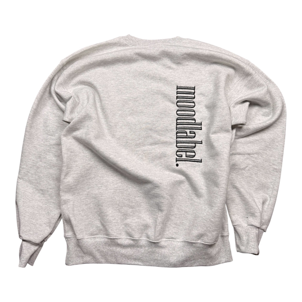Gray sweatshirt with 'moodlabel' text on a white background